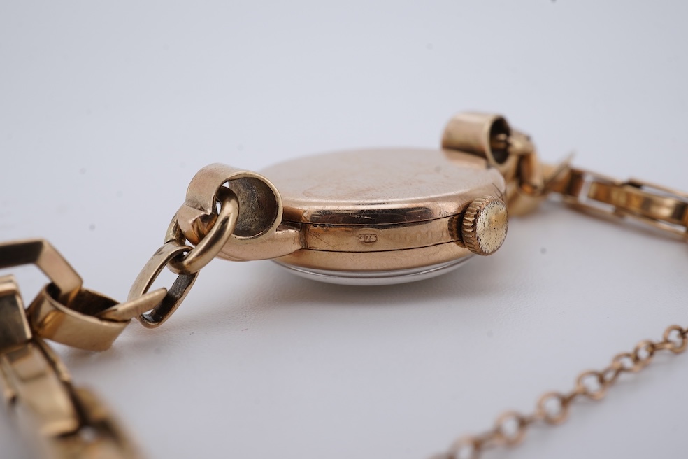 A lady's 9ct gold Record manual wind wrist watch, with Arabic dial and subsidiary seconds, on a 9ct gold bracelet, gross weight 16 grams. Condition - fair